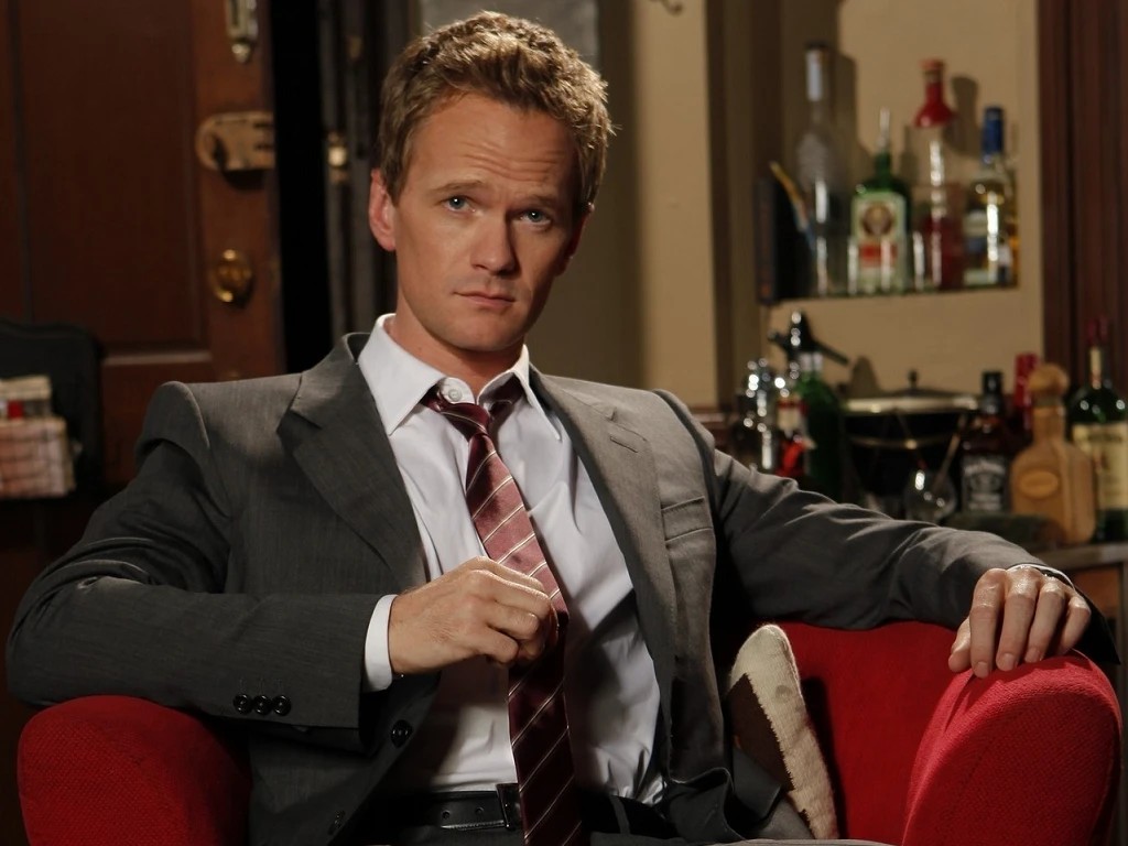 Barney Stinson, suited up in a red armchair