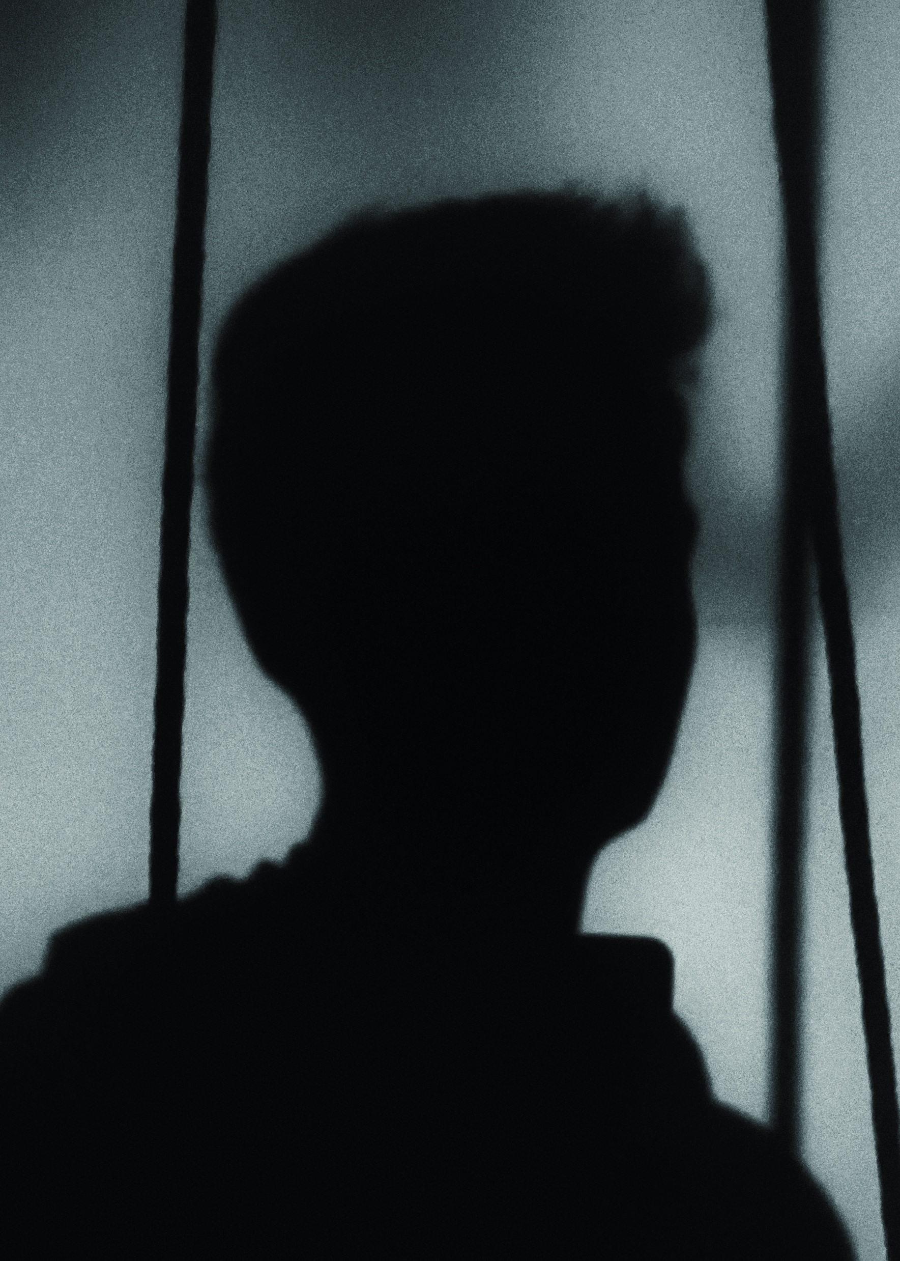 Sharvil Naik, in silhouette against a window
